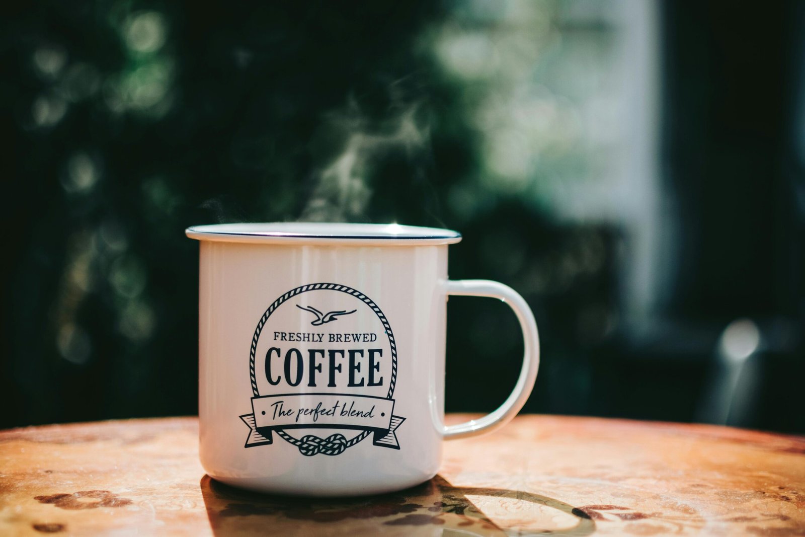 Home Warm coffee mug steaming on a rustic table, evoking cozy morning vibes.
